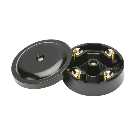 The 20A Junction Box 4-Terminal - Black (59mm) features a round shape, adheres to IP20 standards, and includes a removable lid that exposes the internal brass connectors. The lid is placed next to the open box.