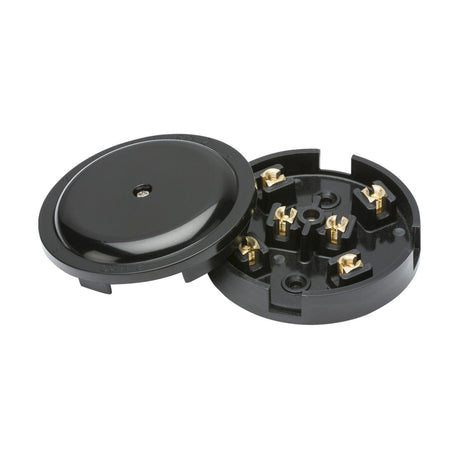 The 20A Junction Box 6-Terminal - Black (89mm) is an open electrical socket made of black plastic, resembling a junction box with a circular base. It features multiple exposed brass screw terminals, and its top cover is slightly angled to the left, highlighting its smooth and shiny surface.