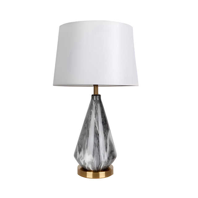 The Calvero 1 Light Diamond Facet Marble Table Lamp features a geometric marble-patterned black and white base, a round brass bottom, and a modern white lampshade.
