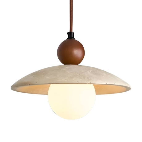 The Trevano 1 Light Dome Travertine Pendant features a round white globe bulb, a wide light beige lampshade, and a walnut brown accent above the shade, all suspended by a brown cord.