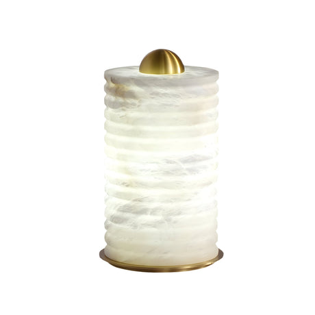 The Aurelior LED Small Ribbed Alabaster Table Lamp – Soft White features a textured, white translucent cylindrical body, gold metallic base, and dome top. It emits soft, diffused light—ideal as a small bedside lamp.