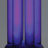 Close-up of the AVSL QTX UV Black Light Bulb B22 20W 365nm twin-tube compact fluorescent lamp glowing purple against a light grey background.