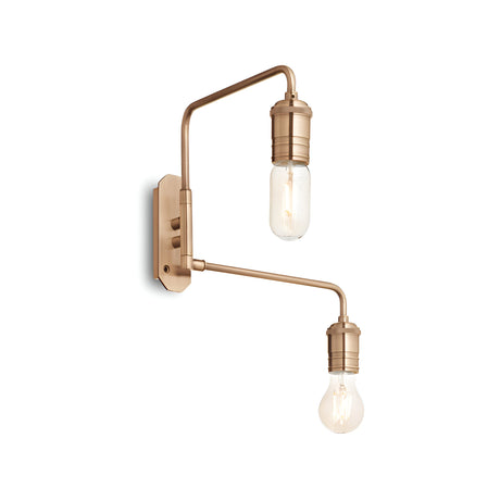 The Lustria 2 Light Wall Light in brass is a modern fixture with two exposed bulbs that boast a sleek, metallic finish. Its design features two arms extending at different angles, each with an adjustable light head, emitting a warm glow that highlights its contemporary design with a touch of vintage lighting charm.