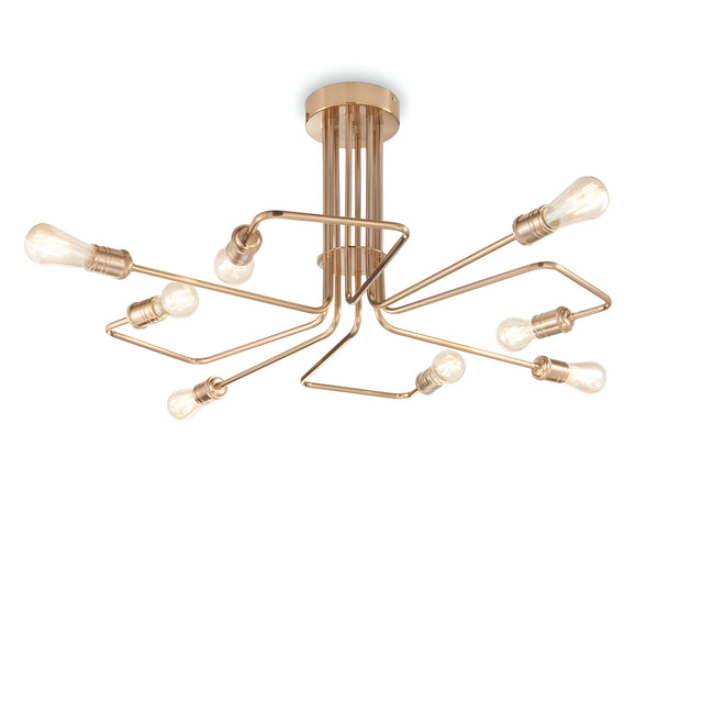 The Lustria 8 Light Ceiling Light in Brass showcases a sleek and artistic design with intertwined metal arms adorned with eight exposed, vintage-style bulbs. It has a modern semi-flush appearance, featuring a gold-toned finish that stands out against a white background.