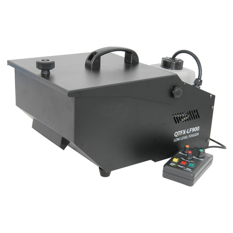 The QTX QTFX-LF900 Low Level Fogger is a black fog machine featuring a convenient handle on top and an array of control buttons on the integrated panel. The model name, QTFX-LF900, is prominently displayed on its side. This device is engineered to work seamlessly with QTX low-level fog fluid, delivering dense and immersive fog effects.