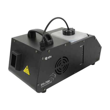 QTX FH-700 700W fog and haze machine in black metal housing with side nozzle, fan grille, translucent fluid tank and level gauge.