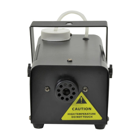 QTX QTFX-400 compact 400W fog machine by AVSL, rear view showing black steel housing, nozzle outlet, white fluid tank cap, tubing, and yellow caution label.