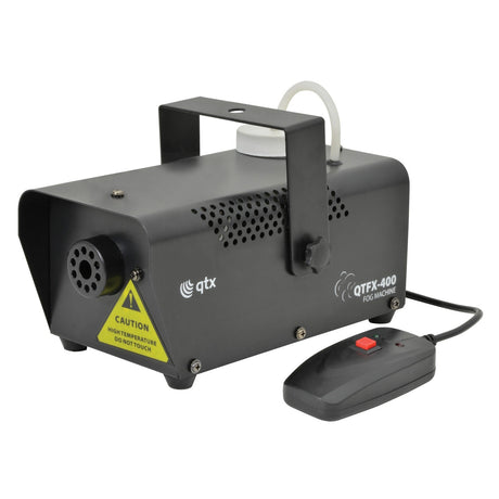 The QTX QTFX-400 Compact Fog Machine in black features a compact design and includes a cable-attached remote. It has a caution label warning of high temperatures, comes equipped with a convenient handle on top, and displays the brand logo prominently on the side.