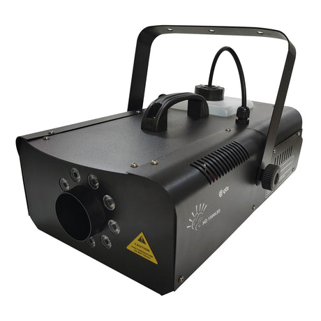 The QTX LED Fog Machine - 1500W boasts a sleek, rectangular design with multiple LED lights at the front and a convenient handle for easy transport. It includes a caution label, a top-mounted tank connected by a tube, and ventilation slots. This machine is equipped with RF wireless remote control and features a 6-channel DMX connection for seamless operation.