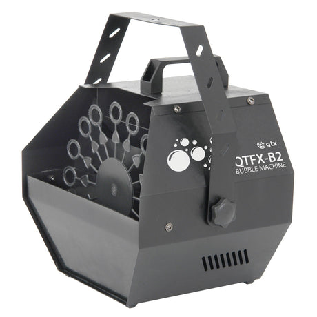 The QTX QTFX-B2 Bubble Machine is a black, portable device equipped with a handle and rotary wand, designed to produce high bubble output for events. It boasts a metallic body with a circular vent and prominently displayed branding on the front.