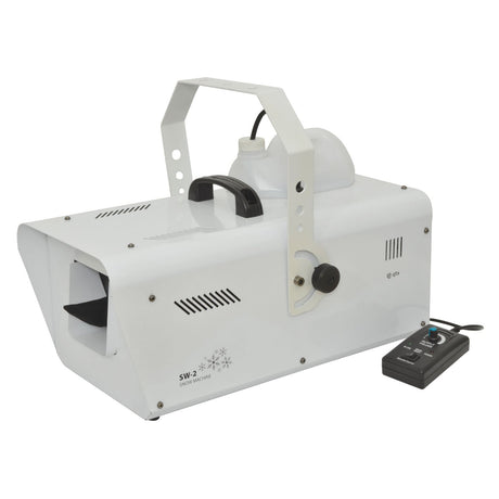 The QTX SW-2 Snow Machine - 1200W is a white device featuring a handle on top and a remote control beside it. Equipped with vents and a nozzle for snow dispersal, it ensures realistic snowfall. The black remote control, connected via cable, allows for precise DMX control of the enchanting display.