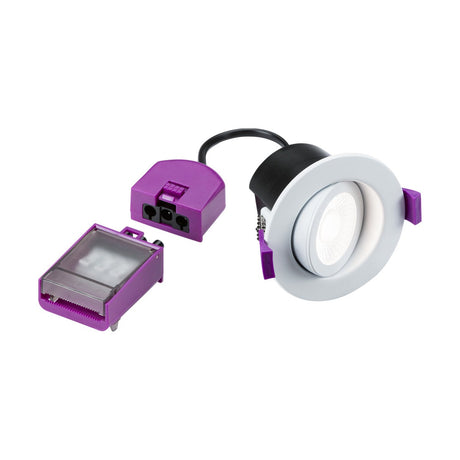 Close-up of the SpektroLED Evo Dimmable Tilt Fire Rated LED 4-CCT Downlight, showcasing a white recessed LED ceiling light with a round bezel, accompanied by a purple connector and separate driver. The setup, displayed on a plain white background, exemplifies SpektroLED's energy-efficient lighting, making it an ideal IP65 downlight solution.