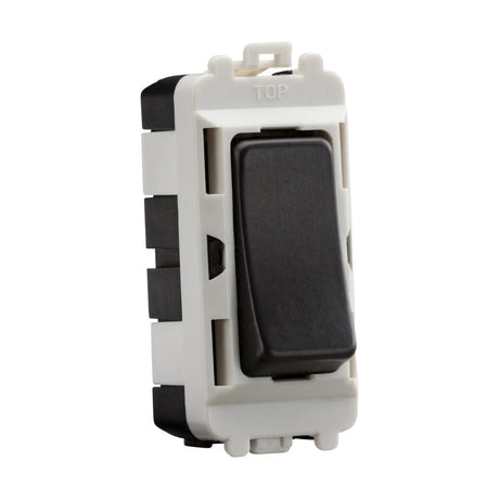 A rectangular rocker switch, designed for electrical installation, features a black and white finish with a top label. This 20AX intermediate module in smoked bronze is part of the Knightsbridge Grid system, mounted in a plastic frame with side clips suitable for wall mounting.