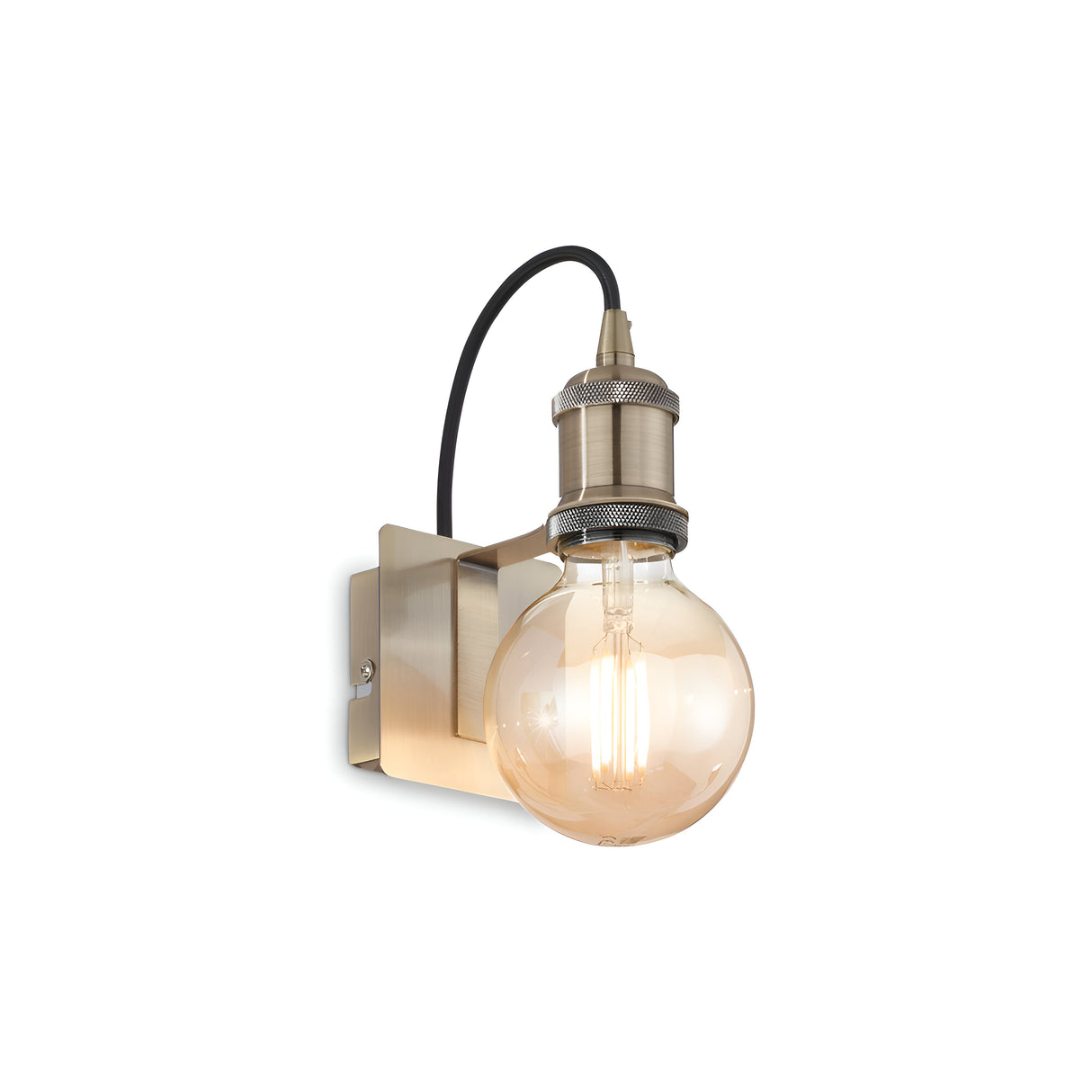 The Zip Wall Light - Brass is a vintage-style wall sconce featuring an exposed filament bulb on a metal bracket, exuding charming vintage aesthetics. Its burnished brass finish and black cord enhance the industrial-inspired design.