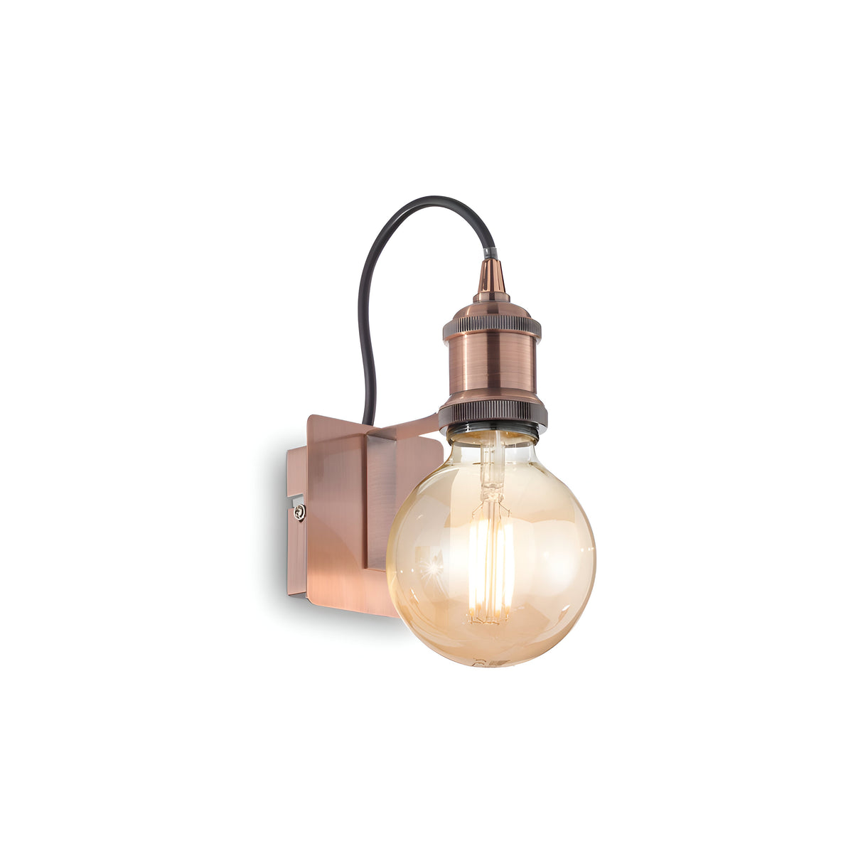 The Zip Wall Light - Copper is a wall-mounted fixture featuring a large, round Edison bulb that showcases an exposed design with visible filaments. This piece connects to the metal base with a black cord, embodying an industrial design and vintage aesthetic that brings timeless charm to any space.