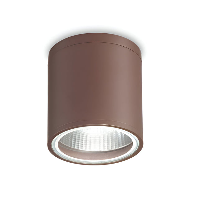 A modern and minimalistic Solar Downlight - Brown is mounted directly onto a white ceiling, featuring a cylindrical design with a glass-covered LED bulb to elegantly illuminate outdoor spaces.