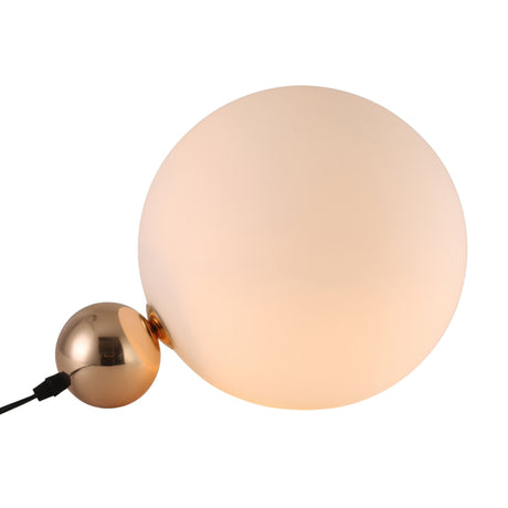 The Soul Table Lamp - Gold is a modern lamp with a large frosted white glass globe and a smaller metallic gold sphere, connected by a black power cord for a minimalistic accent on any flat surface.