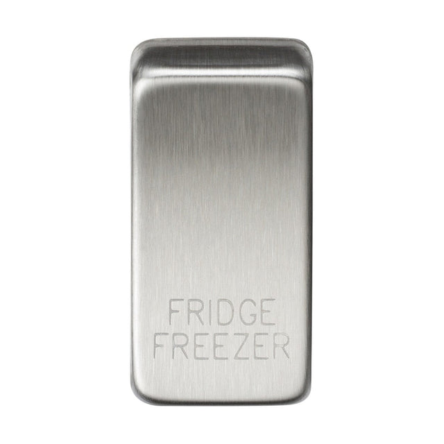 A brushed chrome switch cover featuring engraved text that reads "FRIDGE/FREEZER" on its polished surface.