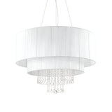 The Brillis Crystal 10 Light Chandelier - White features two cylindrical white fabric shades and crystal pendants arranged in layered tiers, merging elegant lighting with a contemporary design. Ideal for modern interiors, it is suspended by thin wires for a sleek finish.