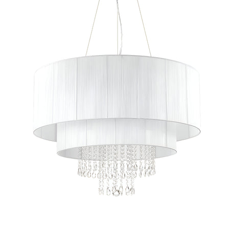 The Brillis Crystal 10 Light Chandelier - White features two cylindrical white fabric shades and crystal pendants arranged in layered tiers, merging elegant lighting with a contemporary design. Ideal for modern interiors, it is suspended by thin wires for a sleek finish.