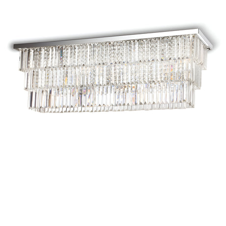 The Fluxon 8 Light Crystal Chandelier - Chrome is a luxurious rectangular ceiling fixture featuring multiple tiers of cascading crystal prisms, all mounted on a reflective chrome finish base. This chandelier creates a shimmering effect that enhances its elegant and modern appearance.