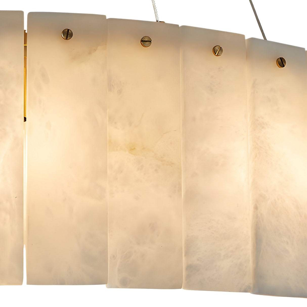 Close-up of the Arvello 12 Light Layered Panel Alabaster Chandelier in soft white and brass, showcasing overlapping rectangular alabaster panels secured with brass accents. The chandelier emits a gentle, warm glow.