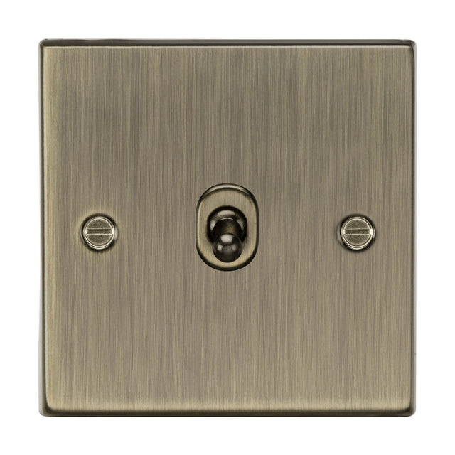 The 10AX 1 Gang 2-Way Toggle Switch - Antique Brass (Square Edge) features a vintage design with a centrally positioned toggle on a square-edge metal plate, complete with two visible screws for classic charm and versatile lighting control.