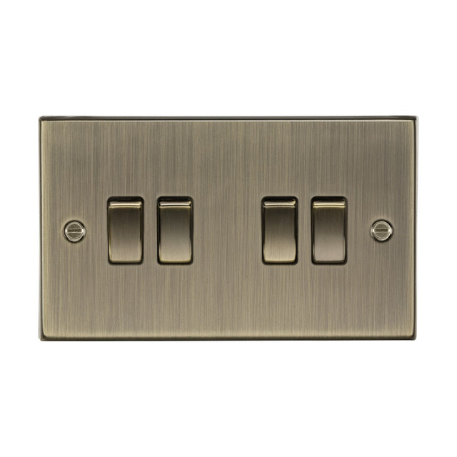 The 10AX 4 Gang 2-Way Plate Switch in antique brass features four rectangular rocker switches with a square-edge design and visible mounting screws, adding a subtle metallic sheen.