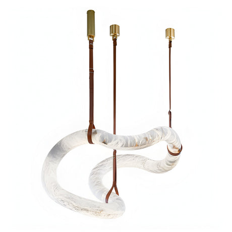 The Serava LED Large Alabaster Asymmetric Suspension Light in Brown & Soft White features a twisted translucent tube, gold fixtures, and leather straps—an elegant modern chandelier that showcases organic Spanish alabaster.