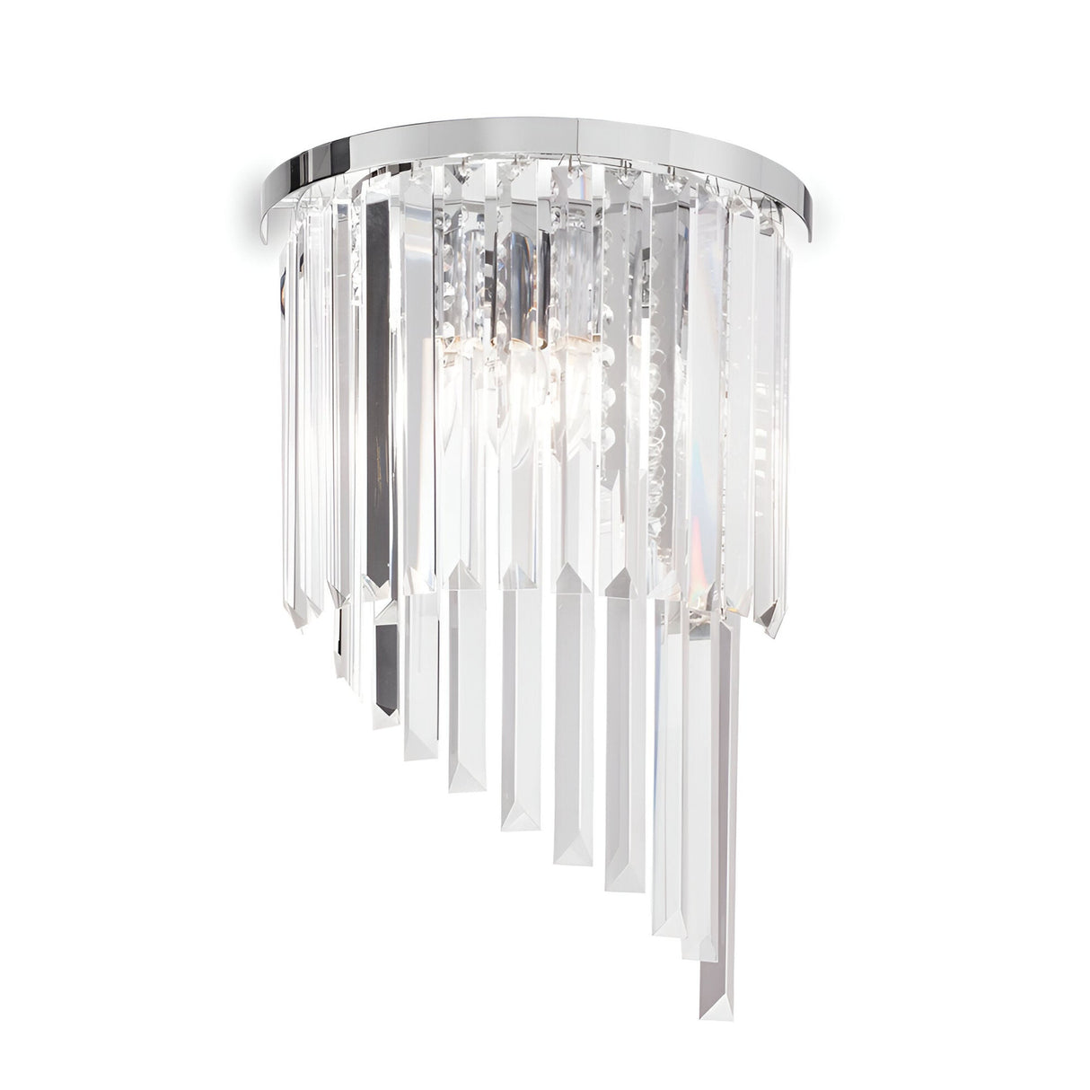 The Emberara 3 Light Crystal Wall Light in chrome boasts a semi-circular base adorned with numerous vertical crystal prisms arranged in a cascading pattern. These crystals beautifully reflect light, offering a luxurious look that complements contemporary interior decor perfectly.