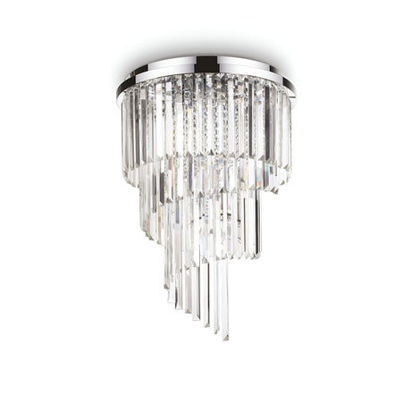 The Emberara 24 Light Crystal Chandelier in chrome showcases a luxurious ceiling light fixture, featuring cascading rectangular crystal prisms arranged in a spiral design. Mounted on a circular chrome base, this exquisite chandelier reflects light brilliantly in multiple directions.