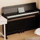 NU-X NCK-330 88-note weighted digital upright piano in black gloss with three pedals and tablet displaying sheet music on the stand, in a home setting.