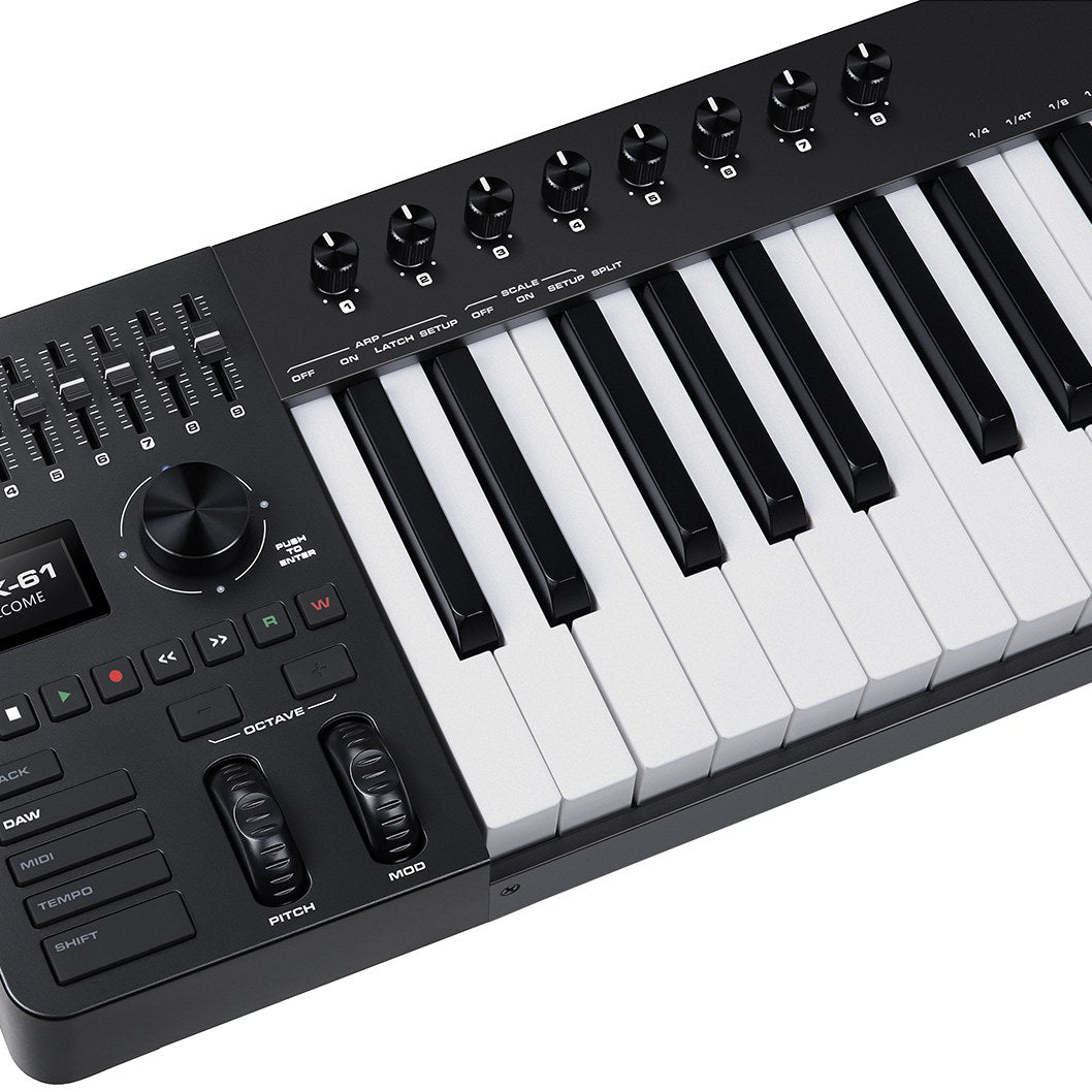 Close-up of the NU-X NTK-61 semi-weighted 61-key MIDI keyboard showing rotary knobs, sliders, display, transport buttons, pitch and mod wheels.
