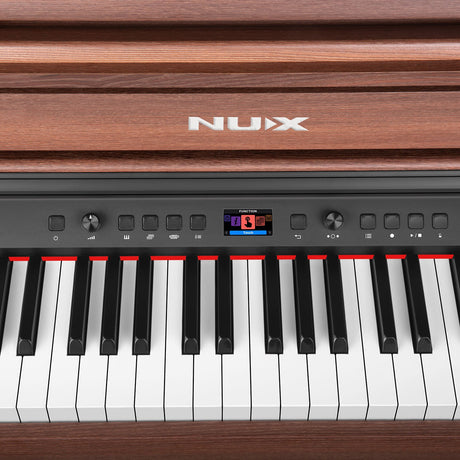 Close-up of the NU-X NCK-430 weighted digital piano in walnut, showing the control panel with colour display, dials, function buttons and weighted keys.