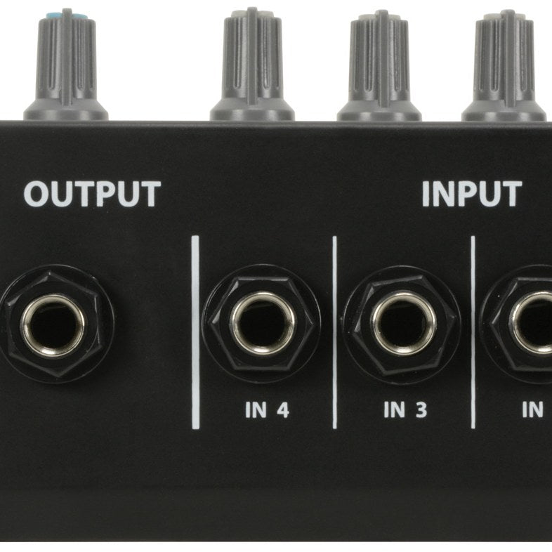 Close-up of the AVSL QTX MM41 4-Channel Mono Mini Microphone Mixer showing the 6.35mm output jack and IN 4, IN 3, IN 2 inputs below grey knobs.