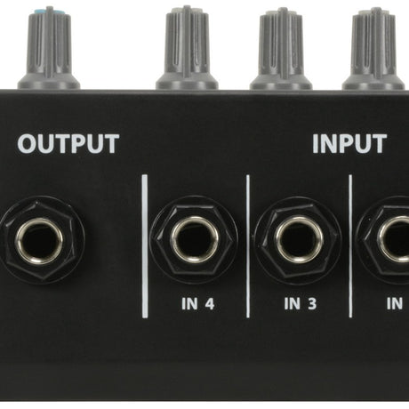 Close-up of the AVSL QTX MM41 4-Channel Mono Mini Microphone Mixer showing the 6.35mm output jack and IN 4, IN 3, IN 2 inputs below grey knobs.