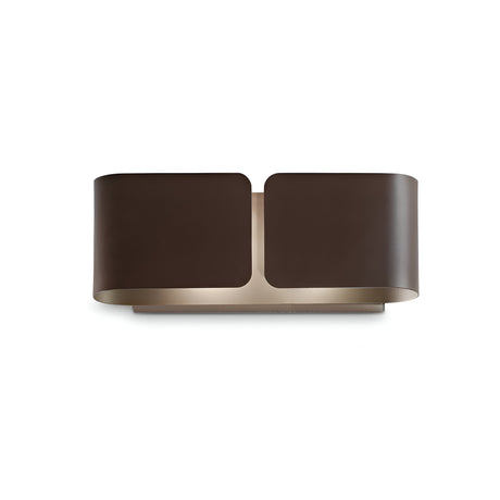 Introducing the Halox 2 Light Mini Wall Light in Brown, featuring a sleek dark bronze finish paired with sandblasted Pyrex glass. Its elegantly curved, symmetrical design with open ends allows for ambient light to diffuse beautifully. This fixture makes a standout statement against a white backdrop.