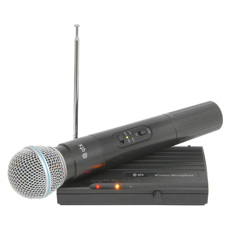 The QTX Handheld Compact VHF Wireless System - 174.5 MHz, featuring a black wireless microphone with a silver mesh head, is positioned on its desktop receiver equipped with antennae, indicator lights, and control buttons. It provides seamless performance for any event with its impressive 50m range.