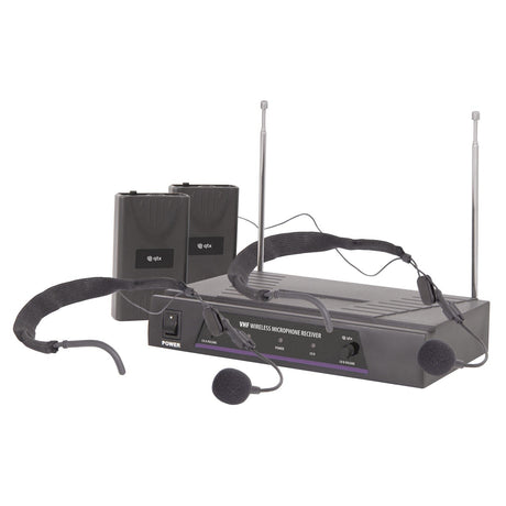 Introducing the QTX Dual Neckband Microphone VHF Wireless System, operating on 173.8 + 174.8 MHz, which includes a receiver unit equipped with dual antennas, two channel beltpack transmitters, and a pair of neckband microphones. The gray units feature control buttons and LED indicators to ensure seamless operation.