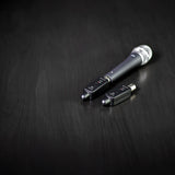 Citronic X24 2.4GHz wireless XLR transmitter and receiver plugged into a handheld dynamic microphone on a dark wood surface.