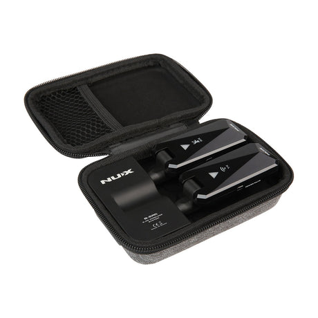 NU-X B-5RC rechargeable 2.4GHz wireless guitar system with black transmitter and receiver units shown inside an open zipped grey carrying case.