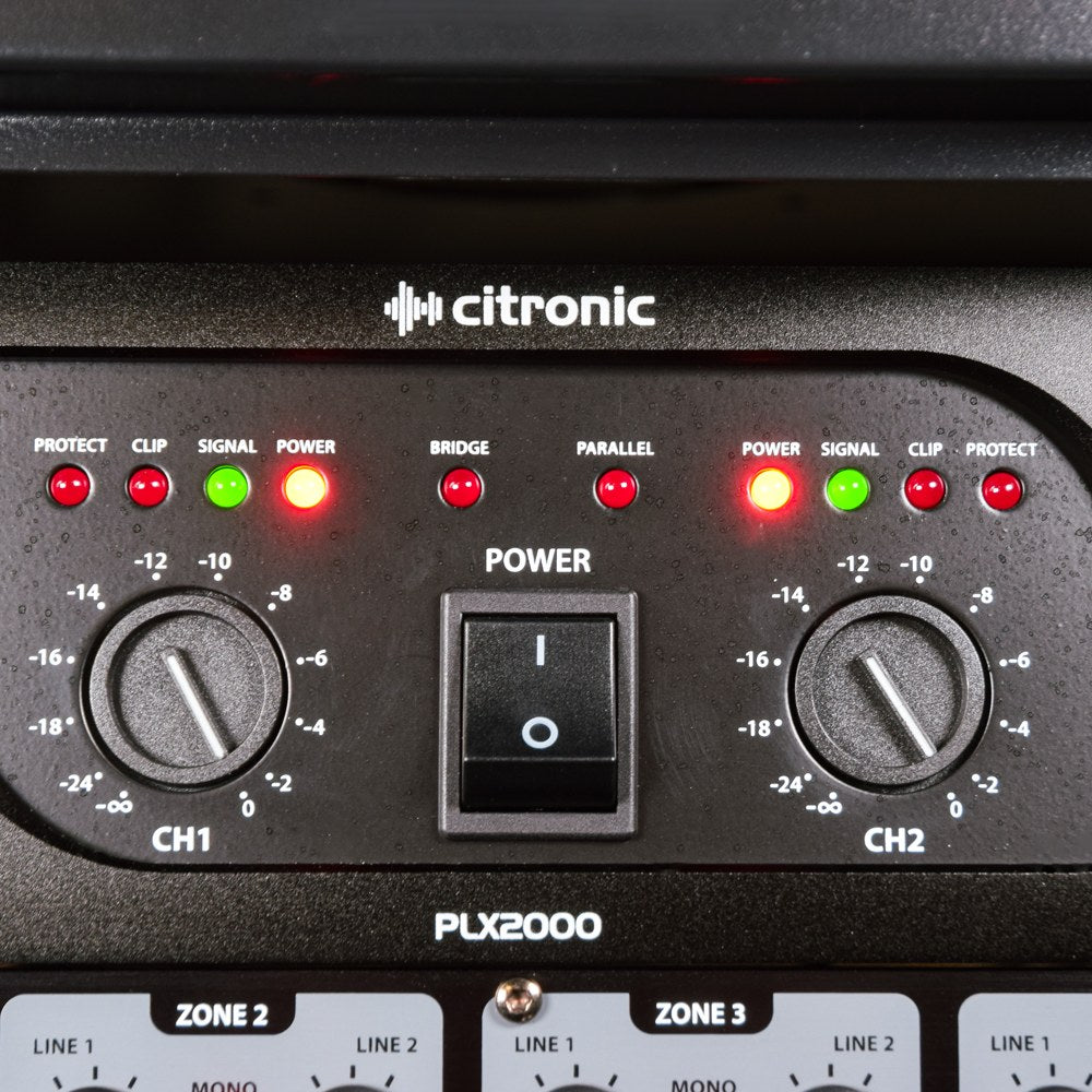 Close-up of the Citronic PLX2000 2U rackmount power amplifier front panel showing lit LED indicators, CH1 and CH2 level dials, and central power switch.