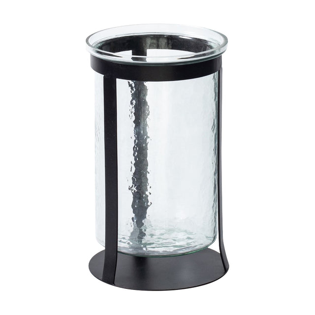 Libra Interiors Hammered Glass Black Iron Hurricane Lantern with a clear textured glass cylinder set in a slim black iron frame on a round base.