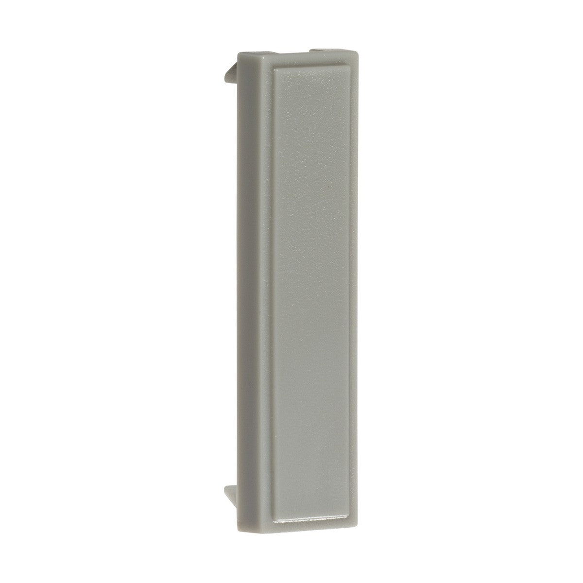 A gray, rectangular object made of plastic with ABS construction, featuring smooth surfaces and a slightly raised edge on one side, similar to modular faceplates, is displayed vertically against a white background. This is part of a pack of 10 Quarter Blanking Modules measuring 12.5 X 50mm each.