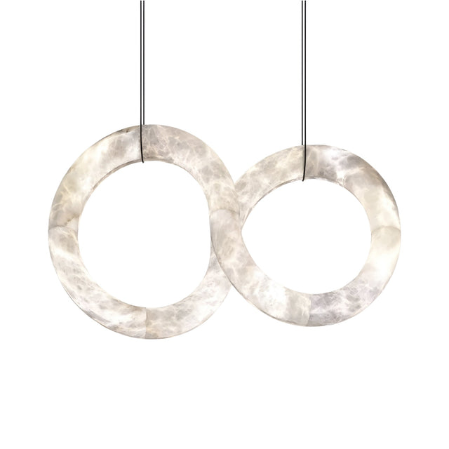 The Serava LED Alabaster Loop Suspension Light – Soft White features two intertwined Spanish alabaster rings, crafted from translucent marble-like material and suspended by thin black cables against a white background.