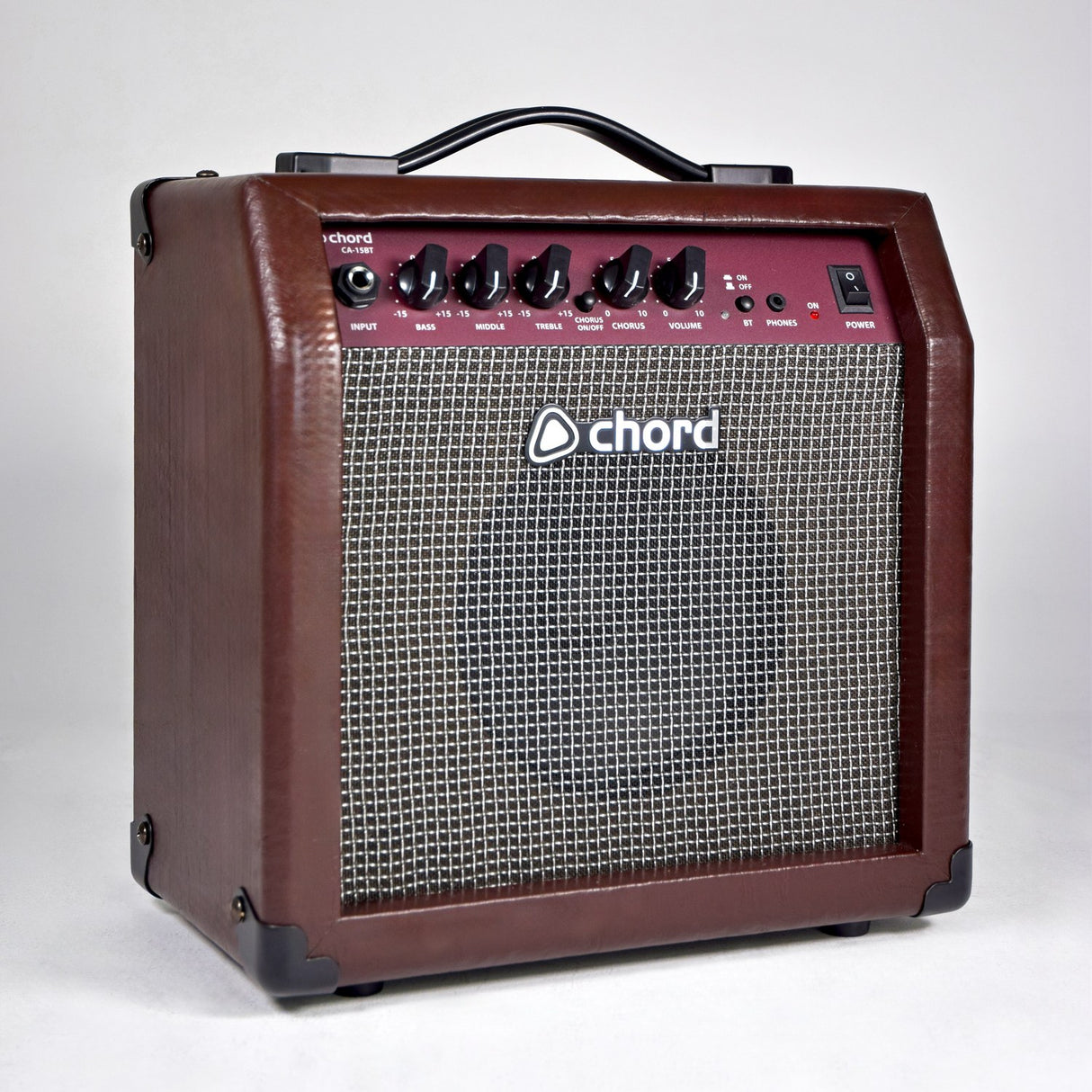 Chord CA-15BT 15W acoustic guitar amp in brown vinyl with basket weave grille, top-mounted EQ and chorus controls, and carry handle on a light background.