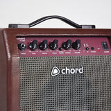 Close-up of the Chord CA-15BT 15W acoustic guitar amp control panel with input jack, bass, middle, treble, chorus and volume knobs, BT, phones and power switch.