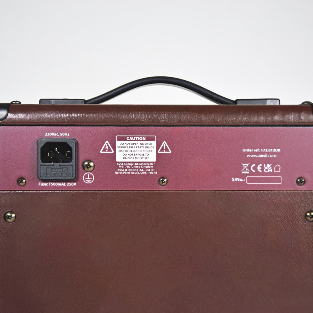 Rear panel of the AVSL Chord CA-15BT acoustic guitar amp, showing brown vinyl casing, IEC power inlet, fuse, caution label and carry handle.