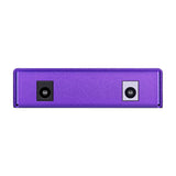 Side view of the NU-X NIP-Z6 Zeus Jr. purple isolated pedal power supply showing black DC input and grey output jack sockets on a white background.