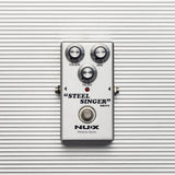 NU-X DIAB Steel Singer analog drive guitar pedal from AVSL with silver casing, Volume, Gain and Filter knobs, and true bypass footswitch on light grey.